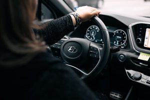 Learner driver hands positioned correctly on the steering wheel of an automatic car