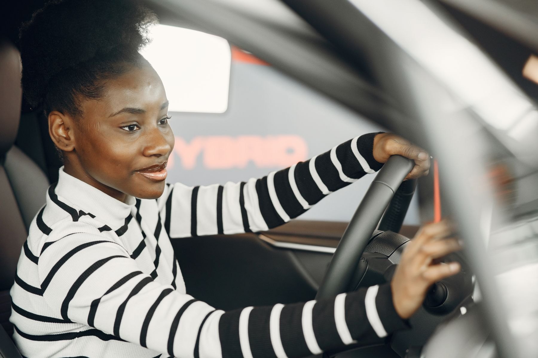 Learner driver smiling at the wheel during an automatic driving lesson in Chester
